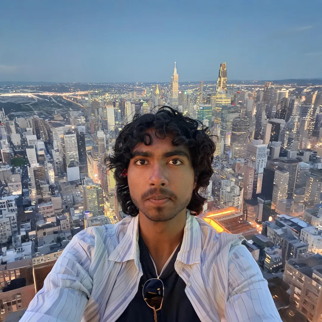 Sanjit above the New York City skyline at dusk